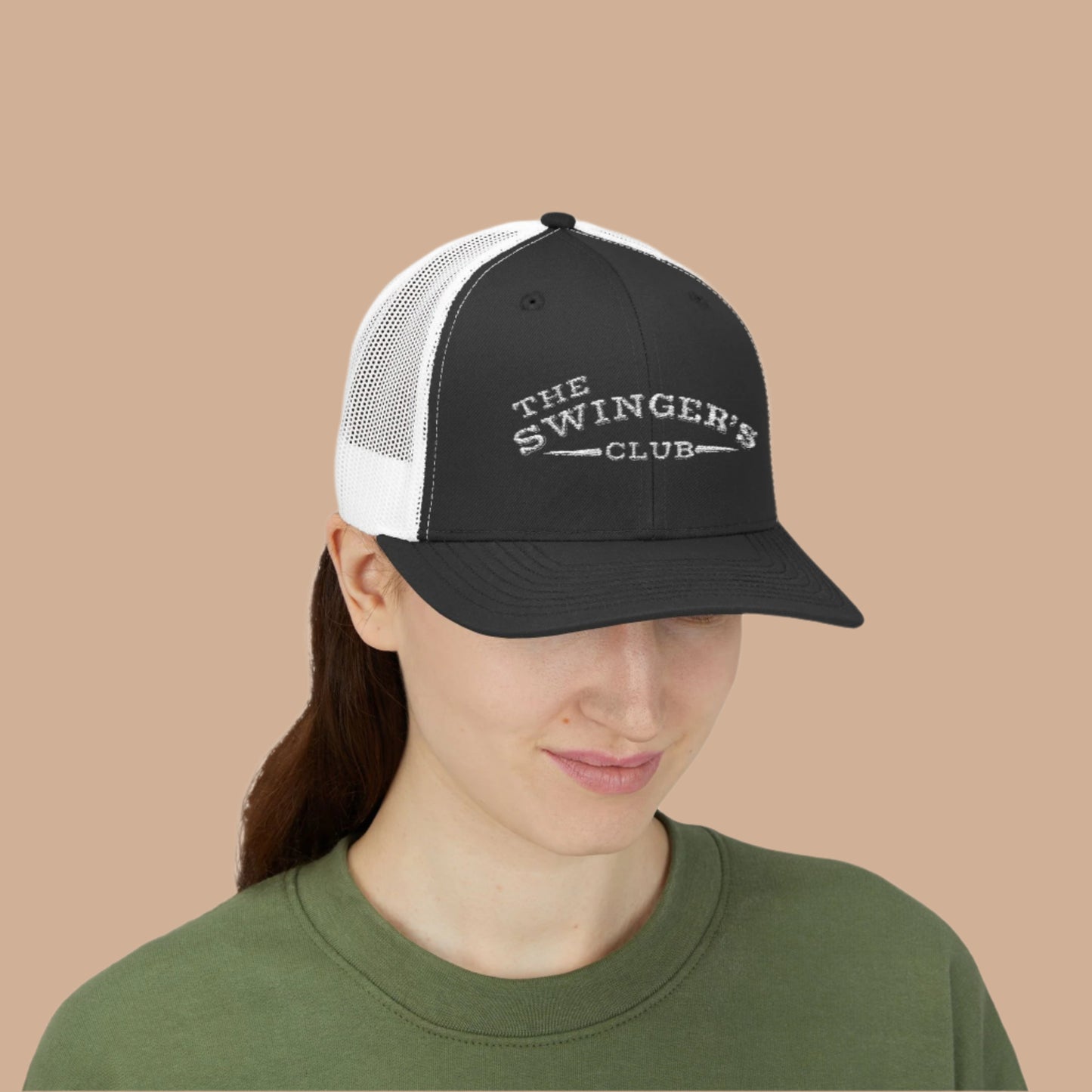 Female model wearing a Navy and White Trucker Hat with a Beige Background