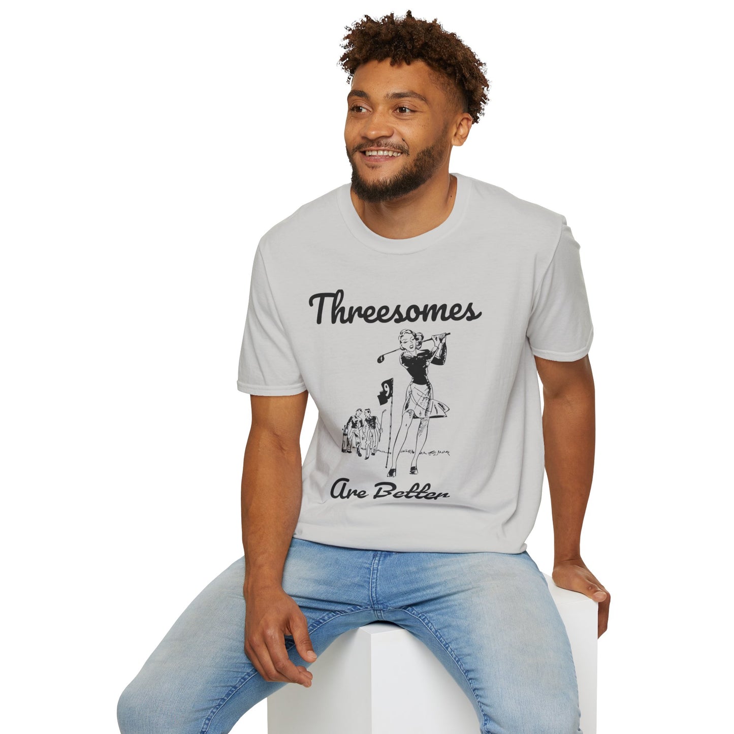 Man wearing a gray t-shirt with graphic design and text, sitting on a white stool against a white background.