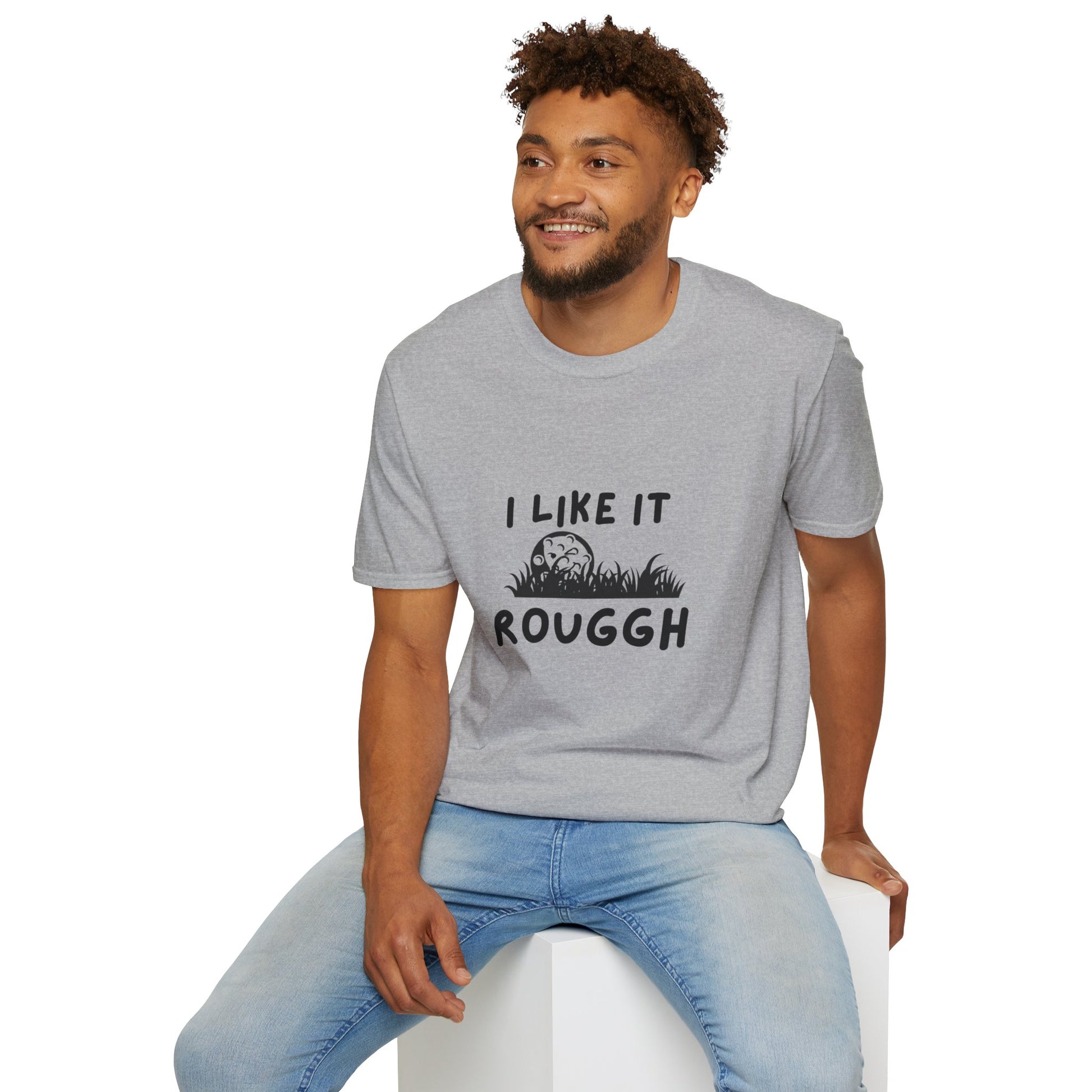 Man wearing a gray t-shirt with text sitting on a white stool against a white background
