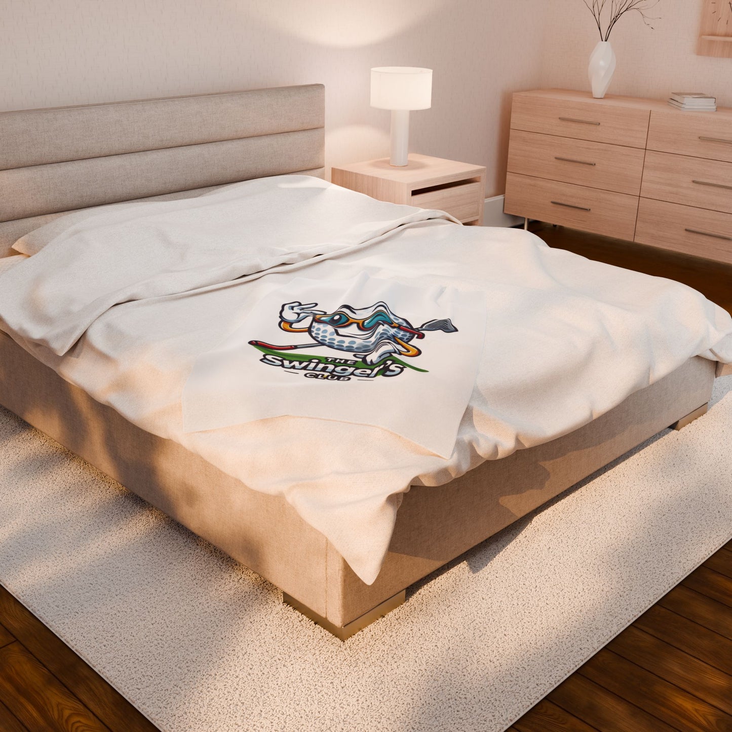 Bed with a white pillow featuring a logo in a bedroom setting