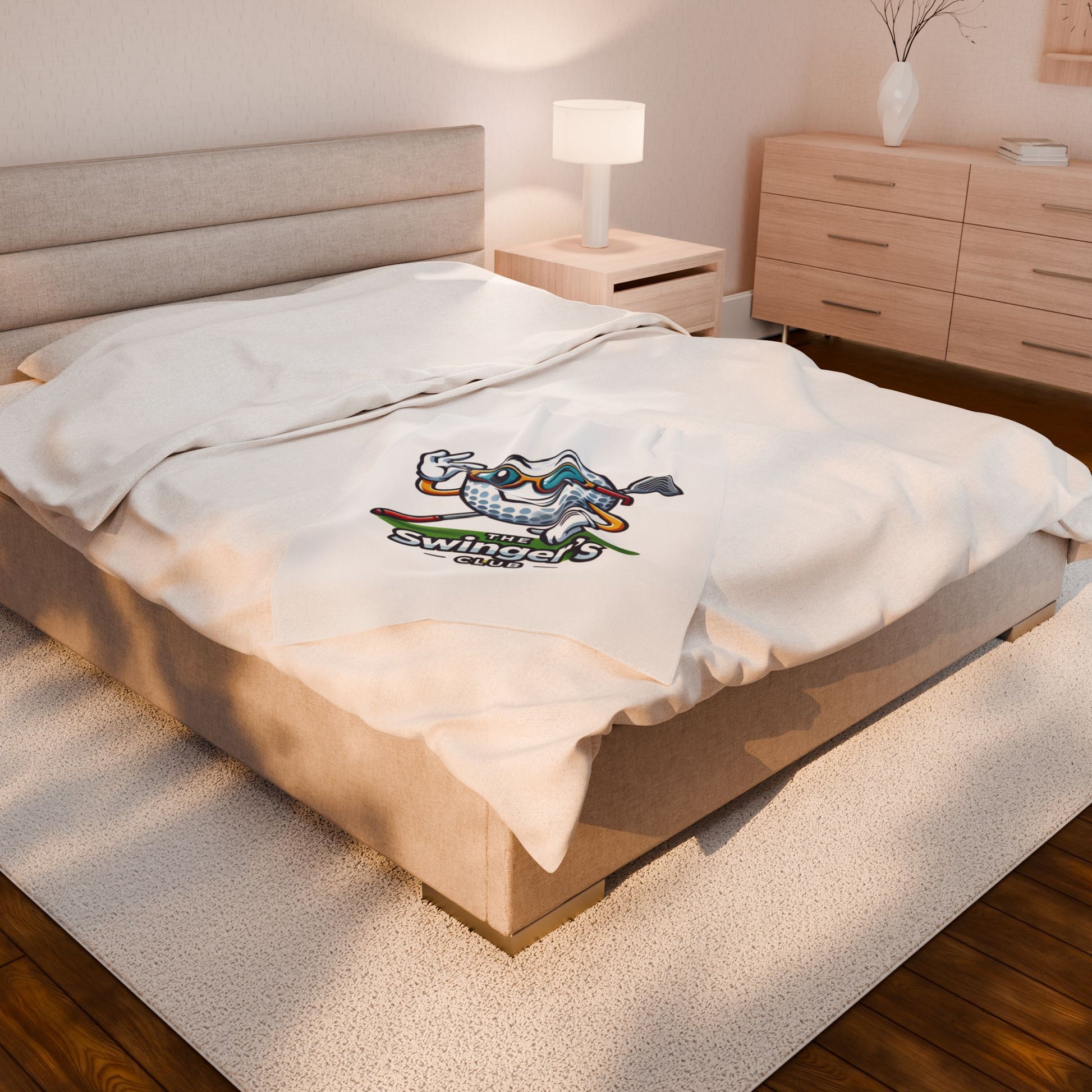 Bed with a white pillow featuring a logo in a bedroom setting